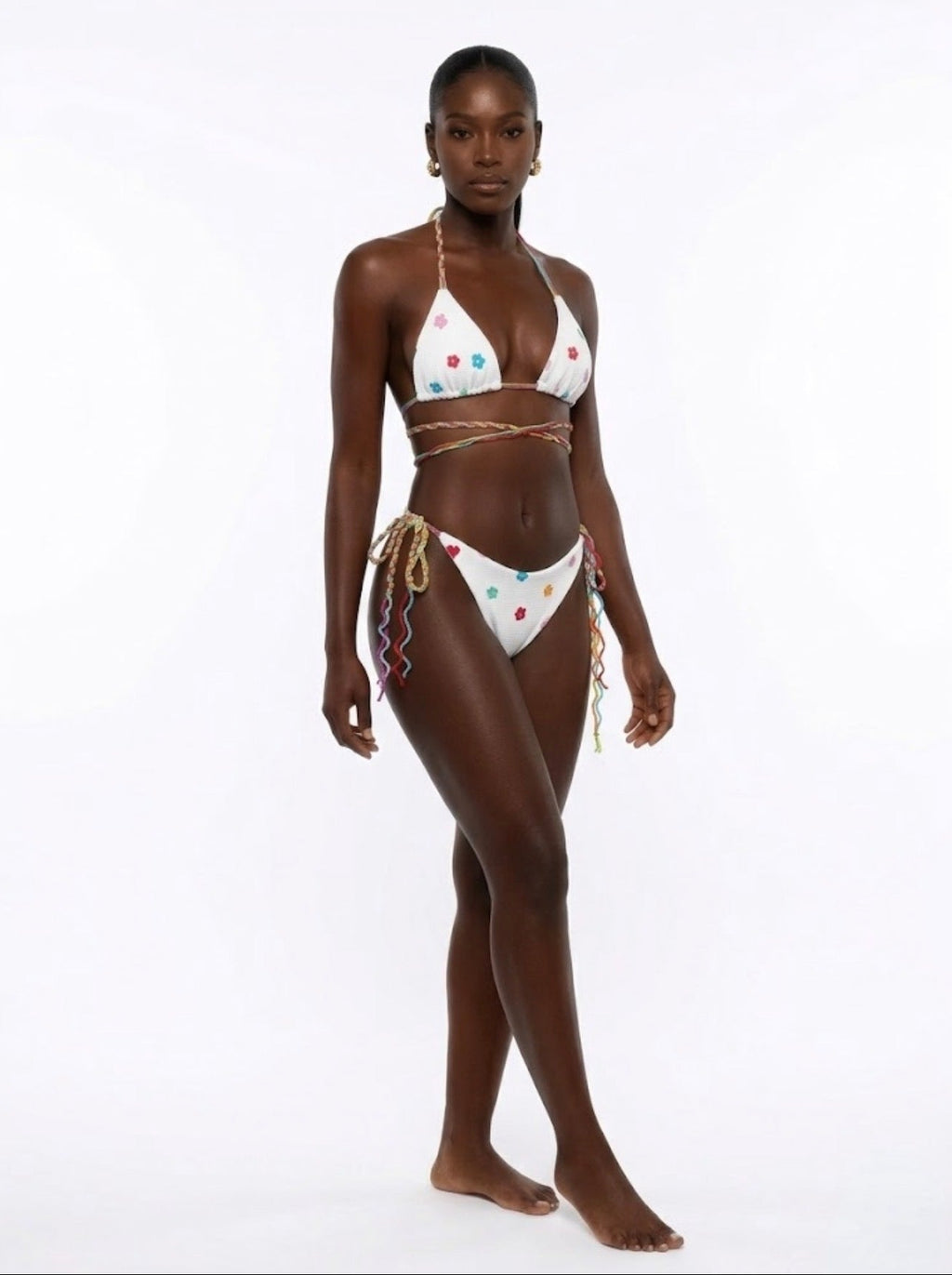 Woman wearing a colorful bikini on a white background