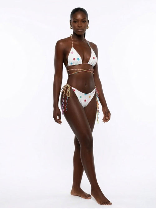Woman wearing a colorful bikini on a white background